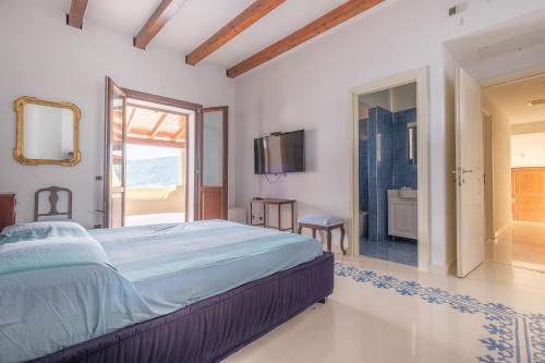 a bedroom with a large bed and a bathroom at Villa Chiara in Lipari