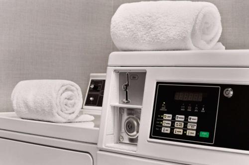 a microwave with towels on top of it in a bathroom at La Quinta by Wyndham Hesperia Victorville in Hesperia