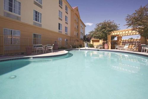 a large swimming pool in front of a building at La Quinta by Wyndham Pueblo in Pueblo