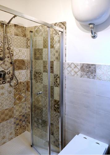 a shower with a glass door in a bathroom at COUNTRY HOUSE in Sezze