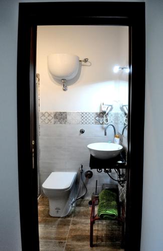 a bathroom with a toilet and a sink at COUNTRY HOUSE in Sezze
