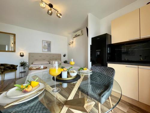 a kitchen and living room with a table and chairs at Holiday Home Mirela in Orebić