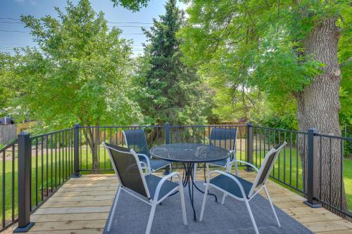 a table and chairs on a deck with a fence at Modern Rapid City Vacation Rental with Deck in Rapid City