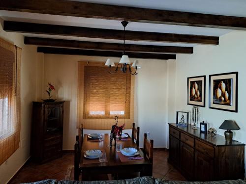 a dining room with a table and chairs and a dining room at Casa El Albero (Torcal-Caminito del Rey) in La Joya