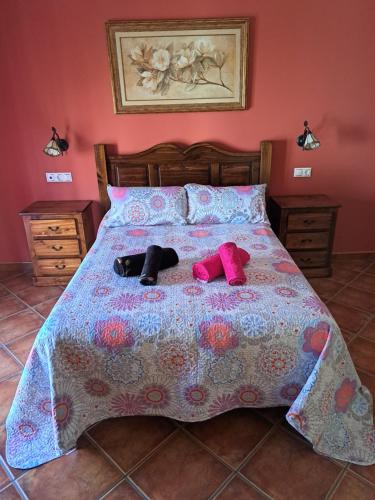 two stuffed animals are laying on a bed at Casa El Albero (Torcal-Caminito del Rey) in La Joya