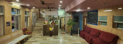 a lobby with a couch and stairs in a building at N S CHITHRA MAHAL in Tiruvannāmalai