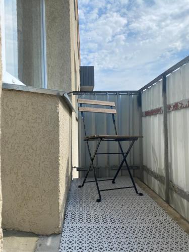 a chair sitting on the side of a balcony at Apartamenti Ezera Pērle in Alūksne
