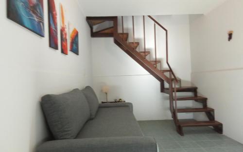 a living room with a couch and a staircase at complejo 25 de mayo in Guaymallen