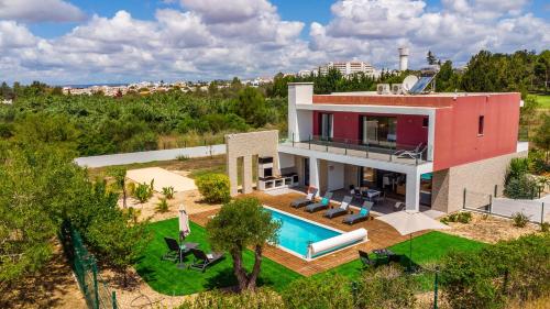 an aerial view of a house with a swimming pool at Casa do Pomar, Piscina Privada, Prainha Alvor! in Alvor