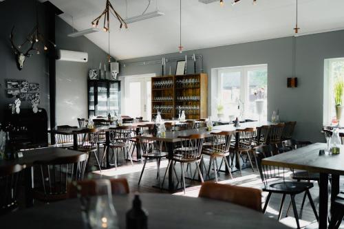 a dining room filled with tables and chairs at STF Korrö B&B in Linneryd