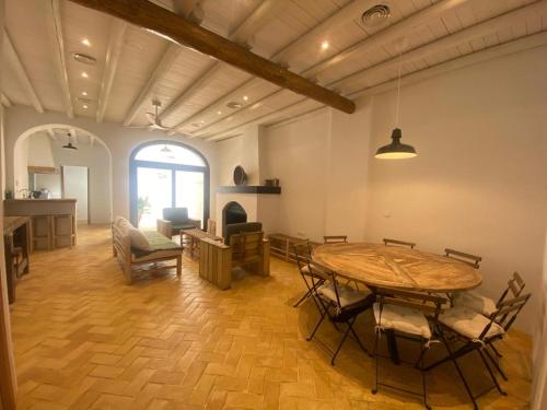 sala de estar con mesa de madera y sillas en Doñana Suite Casa-Hotel, en El Rocío