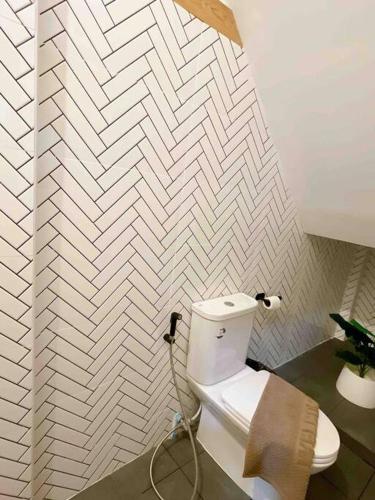 a bathroom with a white toilet in a room at Relax in town,Grand Palace in Bangkok