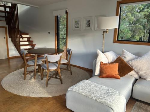 a living room with a couch and a table at EcOasis in Uki