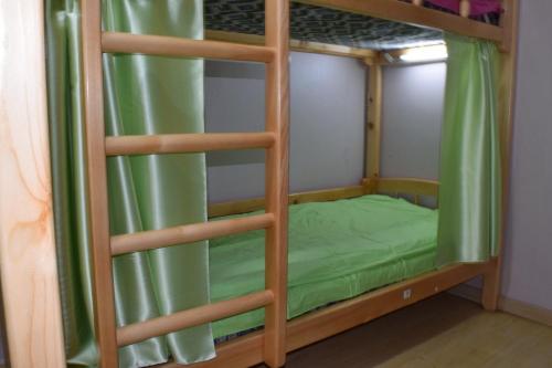 a bunk bed with a green bed in a room at Wonder Mongolia Guesthouse and Tour Operator LLC in Ulaanbaatar