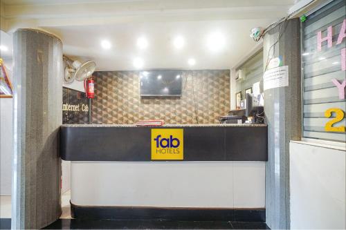 a fast food restaurant with a sign on the counter at FabHotel Shravan in Nagpur