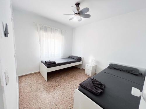 a bedroom with a bed and a ceiling fan at Villa Paz in Villanueva de Castellón