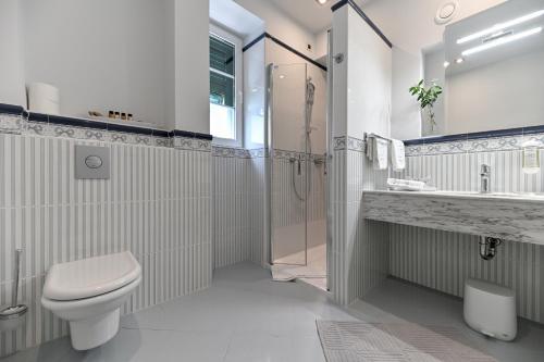 a bathroom with a toilet and a shower and a sink at Villa Hrešć I in Zadar