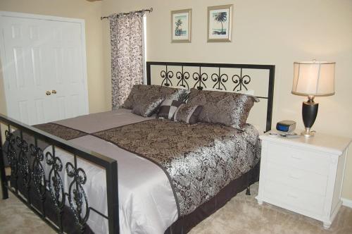 1 dormitorio con cama grande y mesita de noche blanca en Colony Club D8, en Gulf Shores