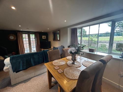 a living room with a table and a couch at Tanyard Cottage - Whixley, York, North Yorkshire in York