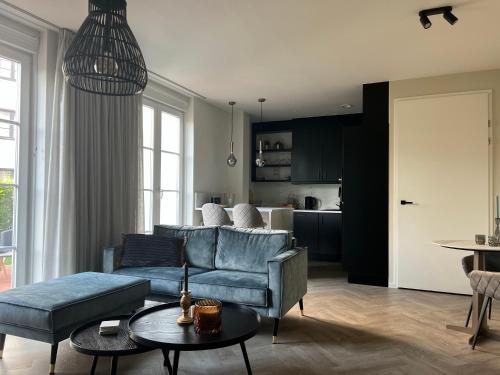 a living room with a couch and a table at Duinhof in Cadzand-Bad