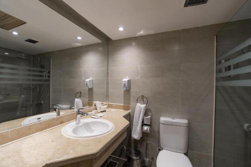 a bathroom with a sink and a toilet at Seven Seas Jolie Bay - Ultra All Inclusive in Hurghada