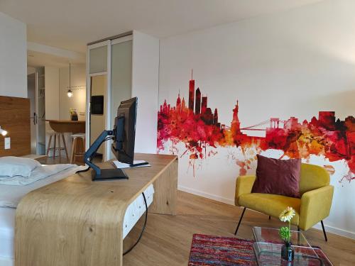 a living room with a desk with a computer on it at ArtRoom Boarding Apartment in Bissendorf