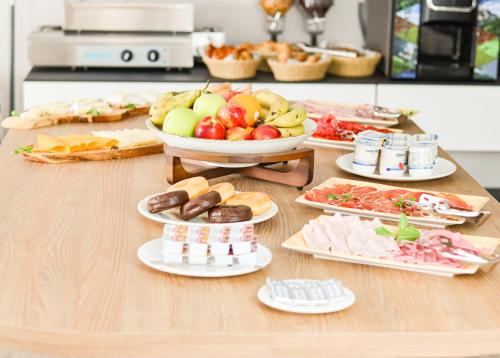 a table with a bunch of different types of food at HOTEL NARCEA in Santa Pola