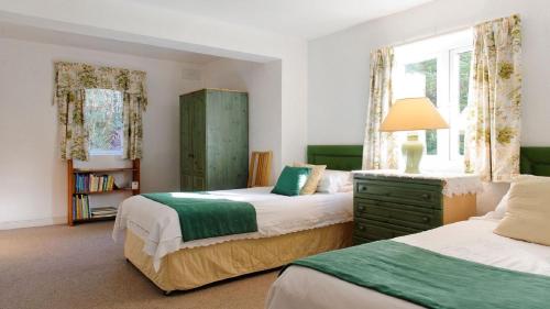 a bedroom with two beds and a window at Doon Cottage, Cashel in Canower