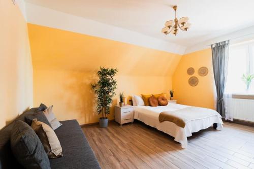a bedroom with a bed and a couch at Market Square - street Rynek 24 -2 Rooms in Wrocław