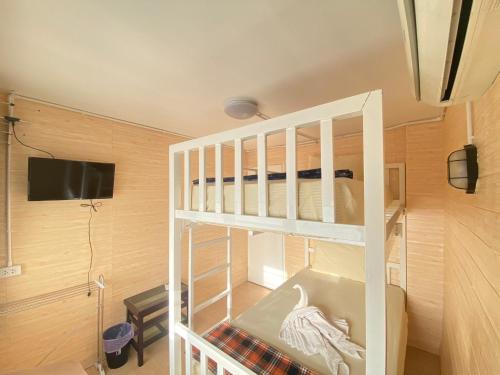 a bunk bed in a room with a tv at Steve Lady Hostel in Bangkok