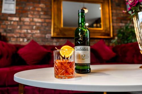 a bottle of wine and a glass on a table at Trafford Hall Hotel Manchester, Trademark Collection by Wyndham in Manchester