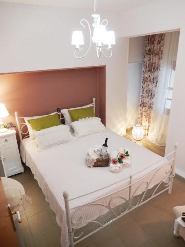 a bedroom with a large white bed with a chandelier at Portico Cozy Home in Kariá