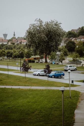 a group of cars driving down a street at Apartman 007 in Vukovar