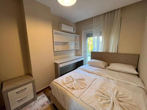 a bedroom with a large white bed with a window at Merkezi, Şık, denize 3 km Kültür kafeler cad. 2 dk '13' in Antalya