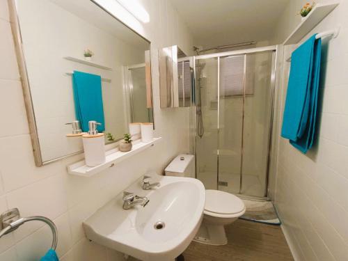 a bathroom with a sink and a toilet and a shower at Villa Service - Torre Barot 5º in Calafell