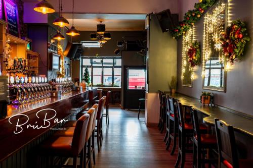 a bar with chairs and a counter in a restaurant at Bru Bar & Hostel in Cork