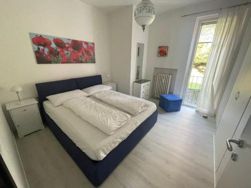 a bedroom with a large bed with a blue frame at Gioia in Oggebbio
