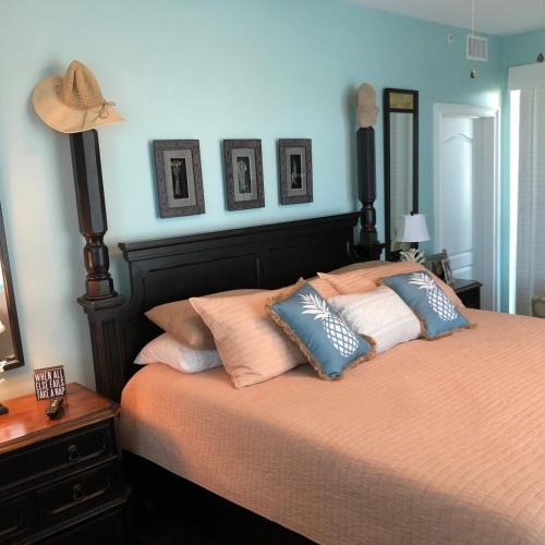 a bedroom with a bed with pillows on it at Indies 110 in Gulf Shores
