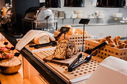 a bakery counter with bread and other items on at City Hotel de Jonge in Assen