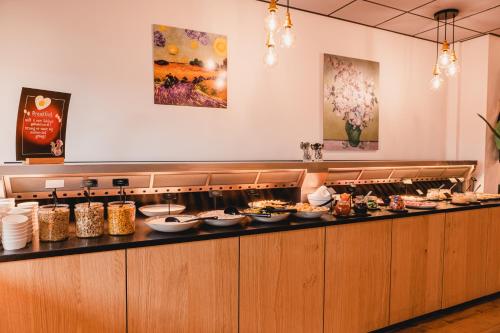 a buffet line with many plates of food at City Hotel de Jonge in Assen