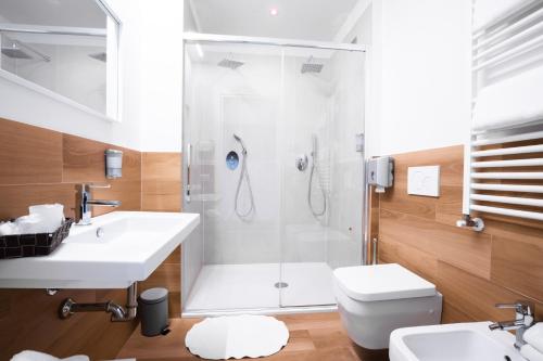 a bathroom with a shower and a sink and a toilet at Hotel Stadio in San Bonifacio