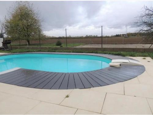 a large swimming pool with a wooden deck at Résidence Foch in Lingolsheim