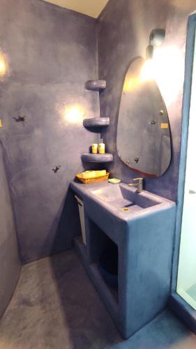 a bathroom with a sink and a mirror at The Sundown Villa in Parasporos