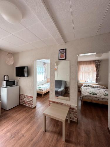 a room with two beds and a table in it at Sirena Holiday Park in Kamchia