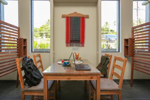 a room with a table with a laptop on it at Damar Toba in Balige