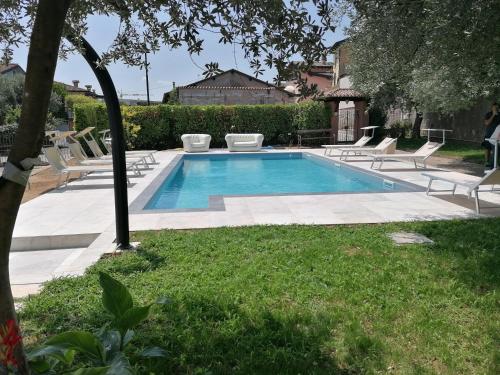 a swimming pool with lounge chairs around it at Hotel San Lorenzo in Pozzolengo