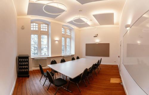 a conference room with a table and chairs at Tagungs und Gästehaus St Georg in Cologne