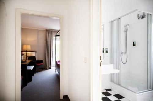 a bathroom with a shower and a sink at Hotel Dieksee - Collection by Ligula in Malente