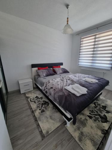 a bedroom with a bed and a rug at Apartman Baban 1 in Kiseljak