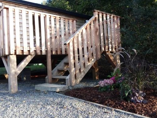 a wooden bridge with stairs in a garden at La Bucolique de Tahier in Ohey
